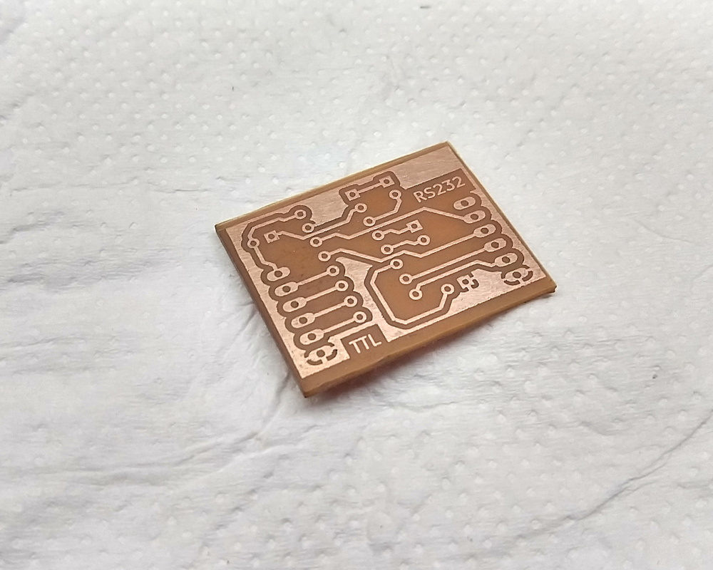 An unpopulated, freshly etched copper circuit board.